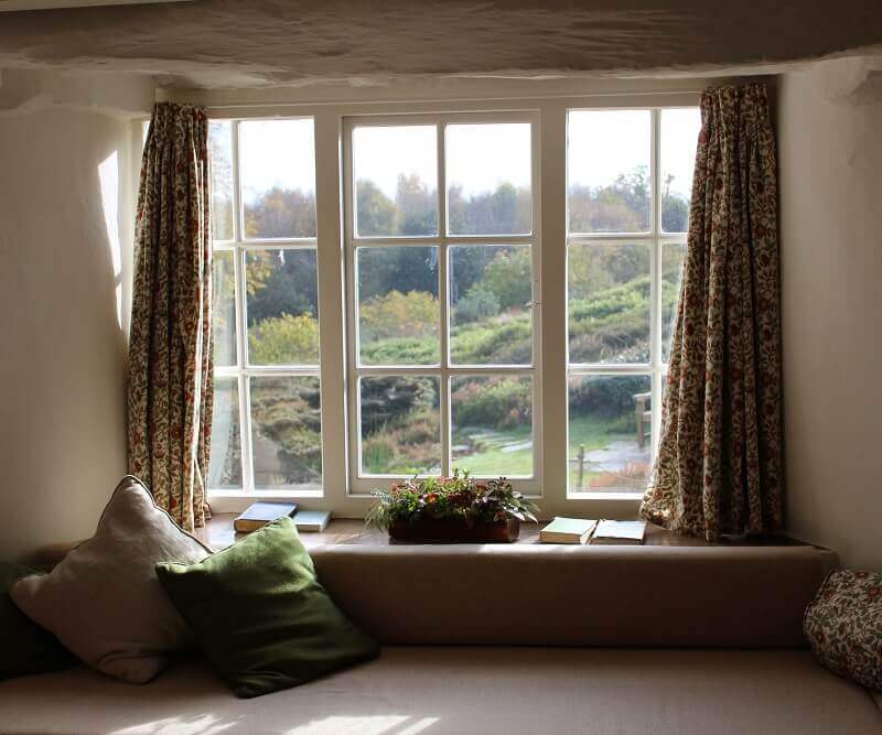 window curtains open during the day sunlight coming into room