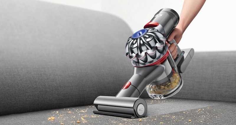 handheld vacuum on sofa